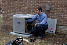 HVAC Service Tech repairing a broker HVAC system at a residential location.