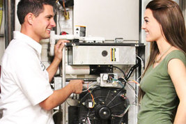 Man and woman talking near a central air and heating unit in a commercial property.